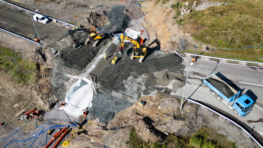Byggnation av en tunnel, med grävmaskiner sedda från ovan. 